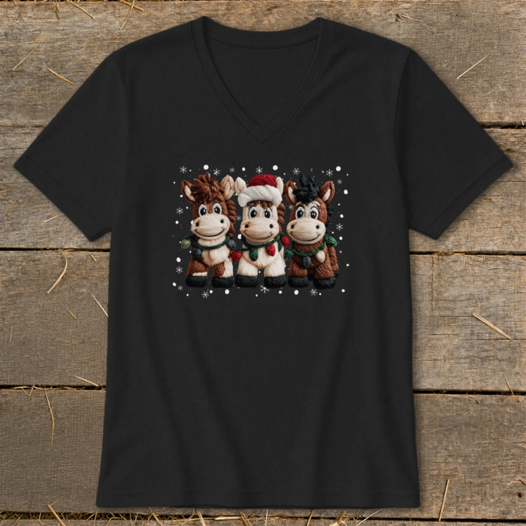 Three cartoon horses wearing holiday scarves and one in a Santa hat with snowflakes.