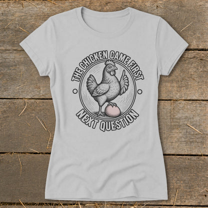 Light grey t-shirt with "The chicken came first, next question" graphic.