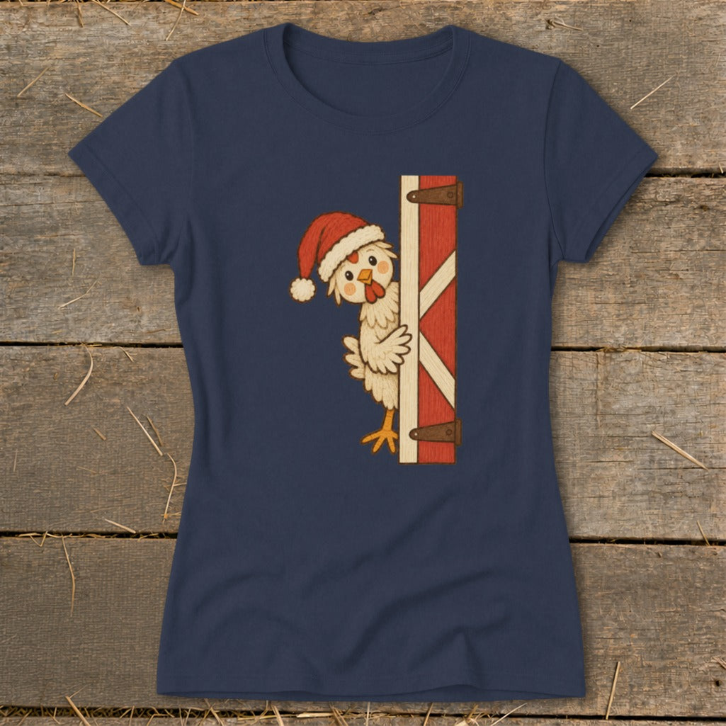 Chicken wearing Santa hat peeking from behind a red barn door.