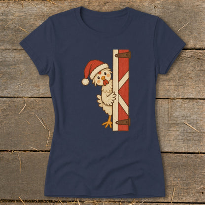 Chicken wearing Santa hat peeking from behind a red barn door.