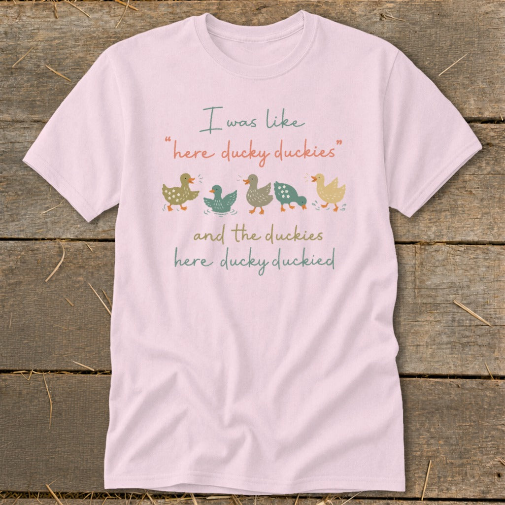 Pink t-shirt with illustration of five ducks and text: "I was like 'here ducky duckies' and the duckies here ducky duckied"