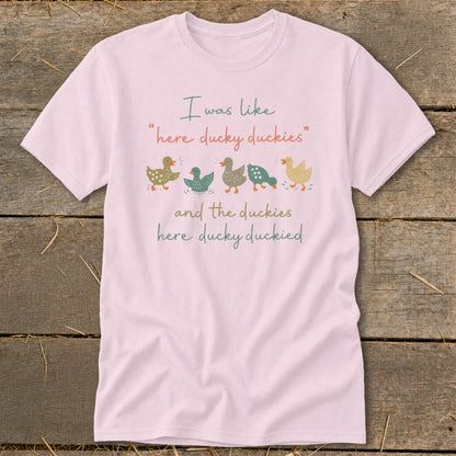 Pink t-shirt with illustration of five ducks and text: "I was like 'here ducky duckies' and the duckies here ducky duckied"