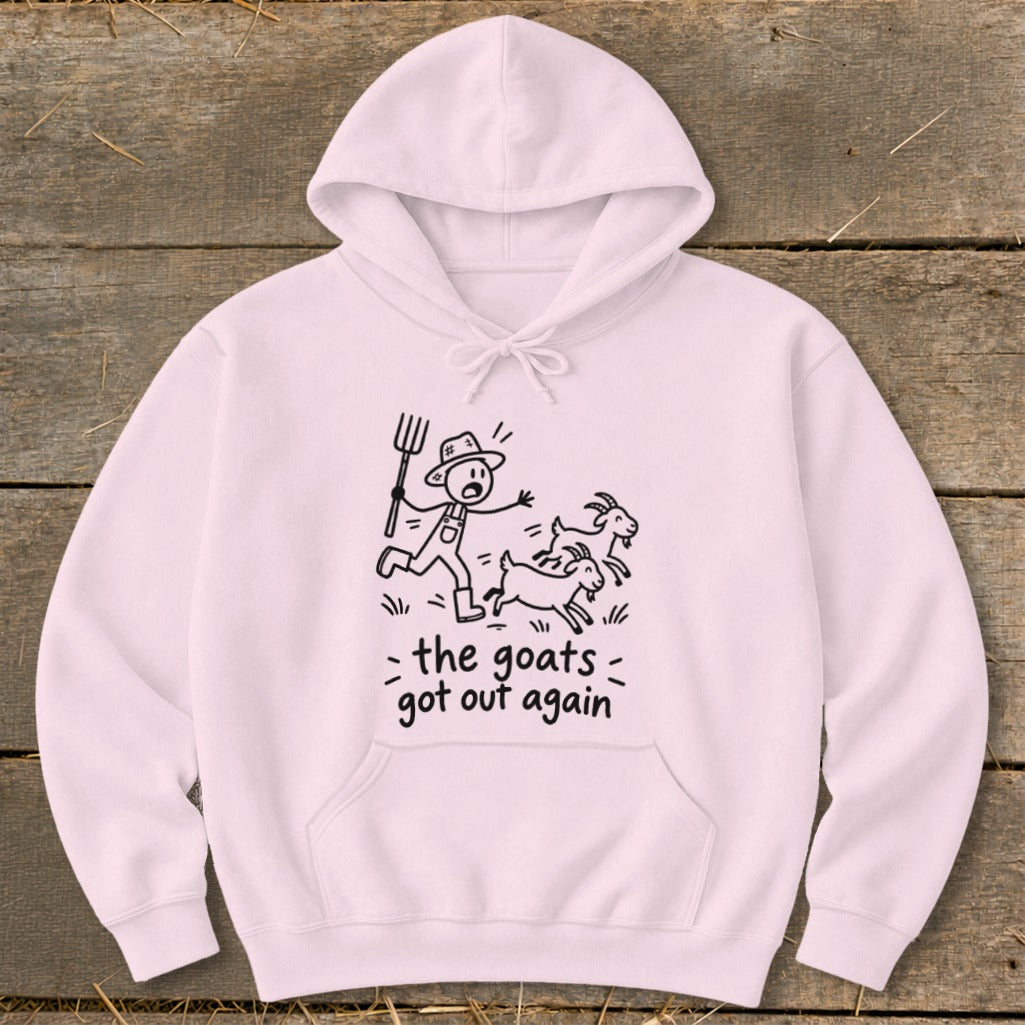 Light pink hoodie with a cartoon farmer chasing goats and text "the goats got out again."