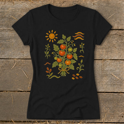 Black t-shirt with a folk art print of a tomato plant, sun, and seeds.