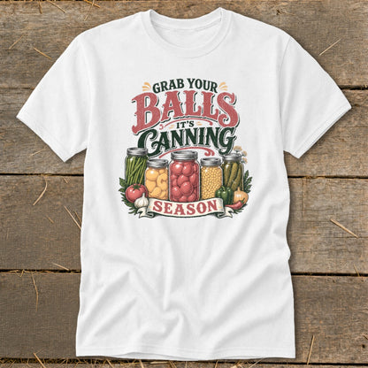White t-shirt with "Grab Your Balls It's Canning Season" text and jars of preserves.