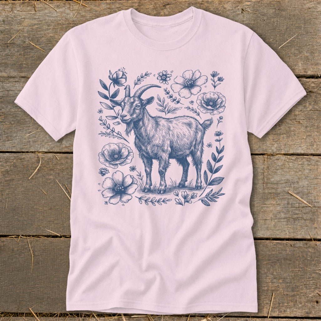 Pink t-shirt with a detailed blue sketch of a goat surrounded by flowers.