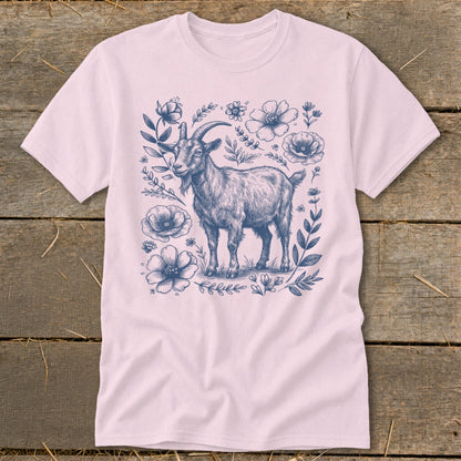 Pink t-shirt with a detailed blue sketch of a goat surrounded by flowers.