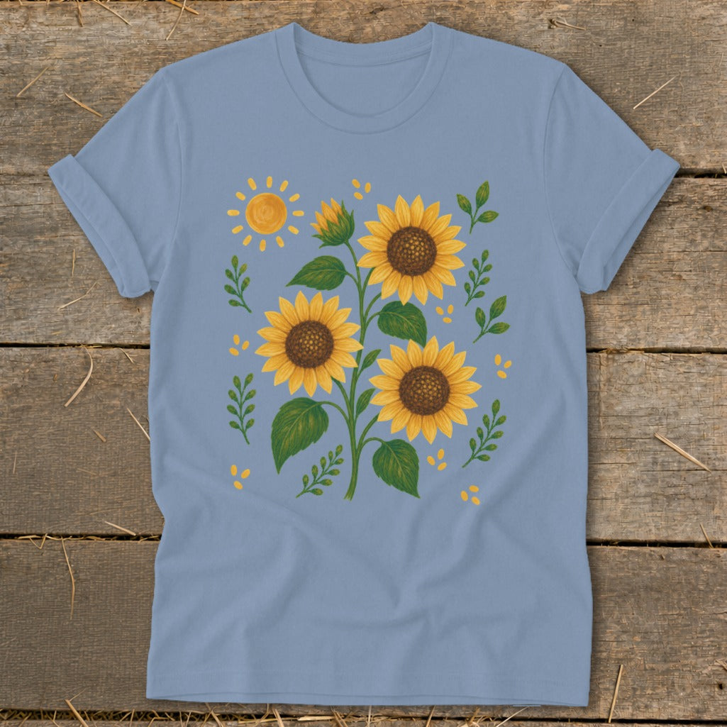 Light blue t-shirt with a graphic of sunflowers, a sun, and leaves.