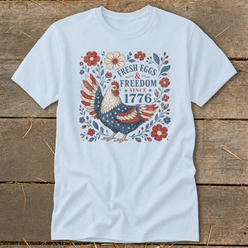 Light blue t-shirt with patriotic chicken and "Fresh Eggs & Freedom Since 1776" text.