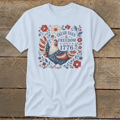 Light blue t-shirt with patriotic chicken and "Fresh Eggs & Freedom Since 1776" text.