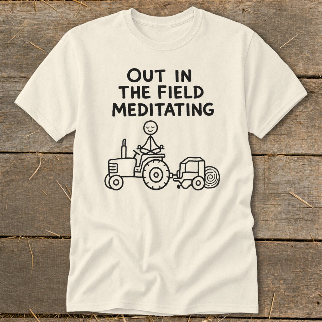 T-shirt with "OUT IN THE FIELD MEDITATING" text, a stick figure meditating on a tractor.