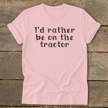 Pink t-shirt with black text that reads "I'd rather be on the tractor."