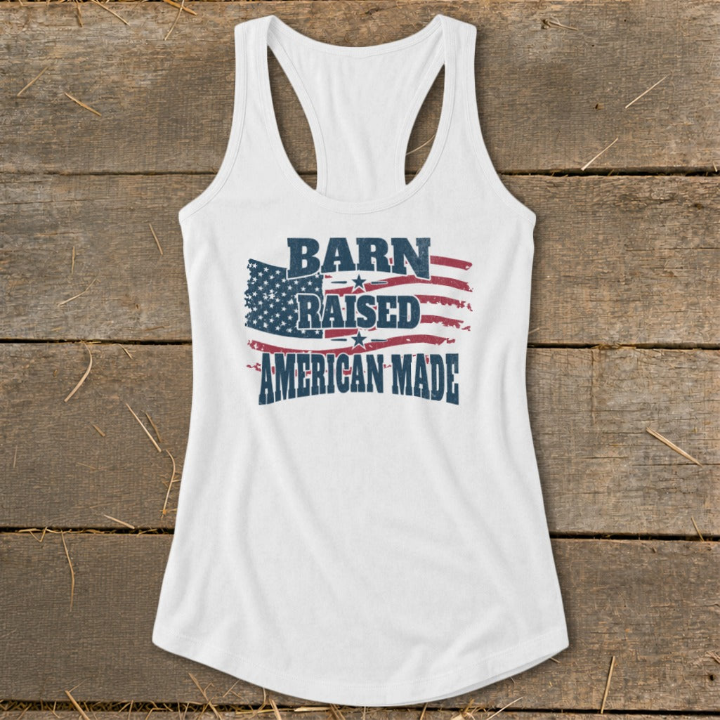 White tank top with "Barn Raised American Made" and distressed American flag graphic.