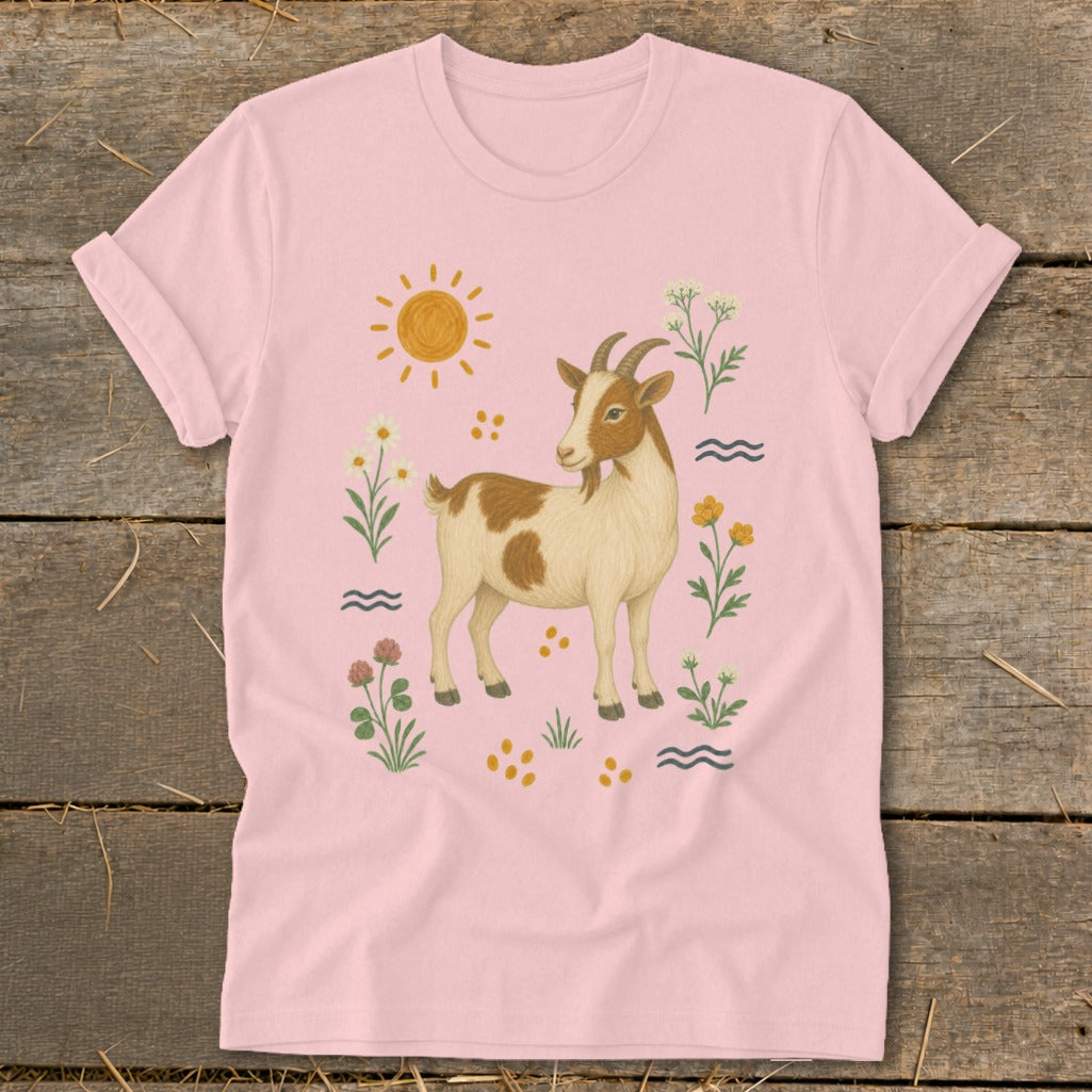 Pink t-shirt with a brown and white goat surrounded by flowers and a sun.