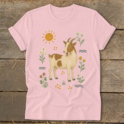Pink t-shirt with a brown and white goat surrounded by flowers and a sun.