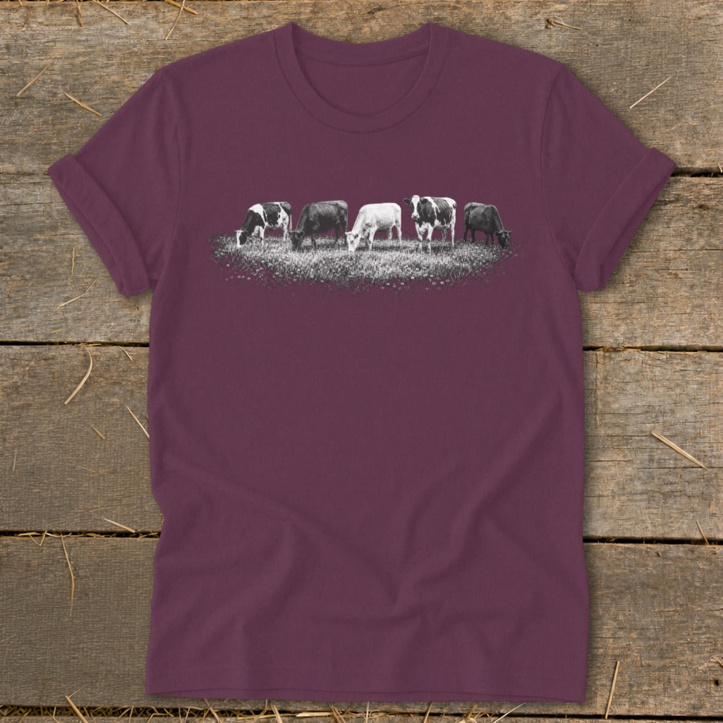 T-shirt with a graphic of five cows grazing in a field.