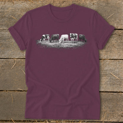 T-shirt with a graphic of five cows grazing in a field.