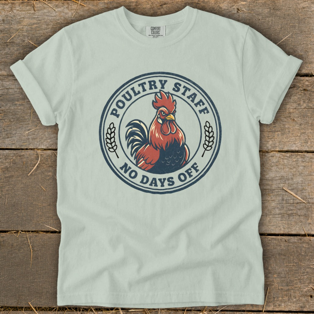 Light blue t-shirt with a circular graphic of a rooster and text.