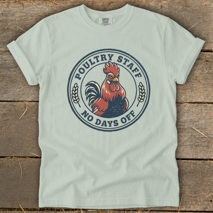 Light blue t-shirt with a circular graphic of a rooster and text.