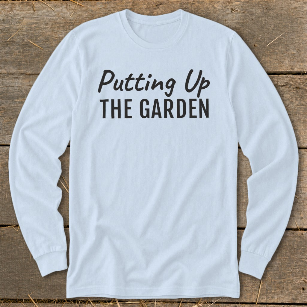 Light blue long-sleeve shirt with "Putting Up THE GARDEN" text in black.