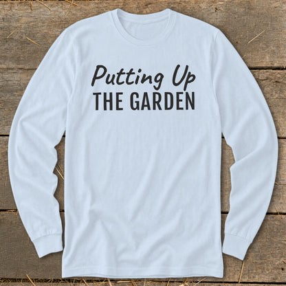 Light blue long-sleeve shirt with "Putting Up THE GARDEN" text in black.