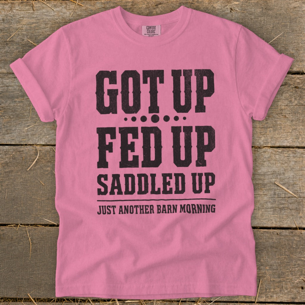 Pink t-shirt with black distressed text: GOT UP, FED UP, SADDLED UP JUST ANOTHER BARN MORNING