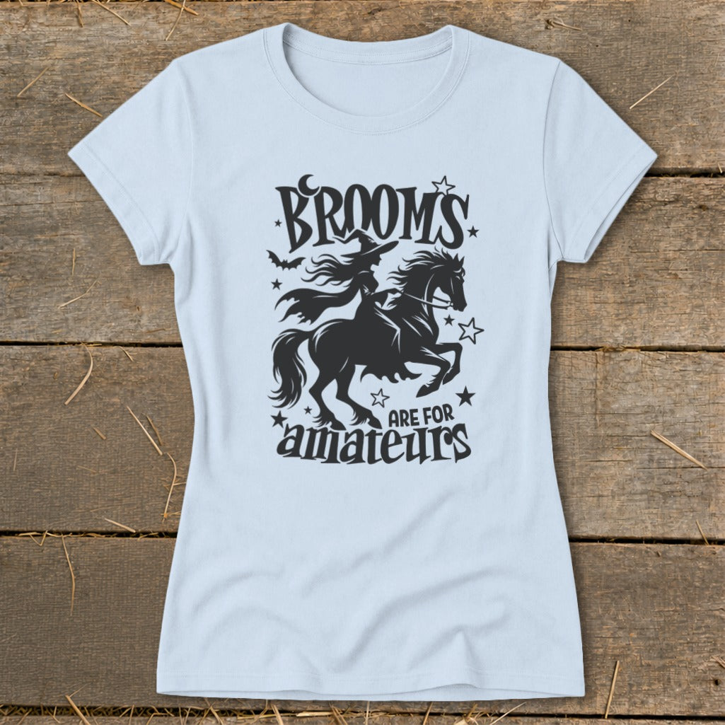Light blue t-shirt with "Brooms are for amateurs" witch and horse graphic.