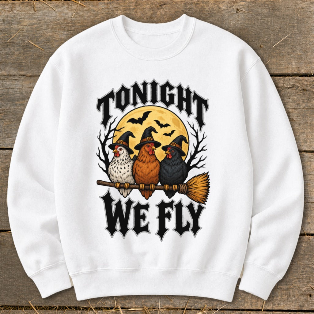 Three chickens in witch hats ride a broomstick with text "Tonight We Fly".