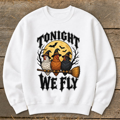 Three chickens in witch hats ride a broomstick with text "Tonight We Fly".