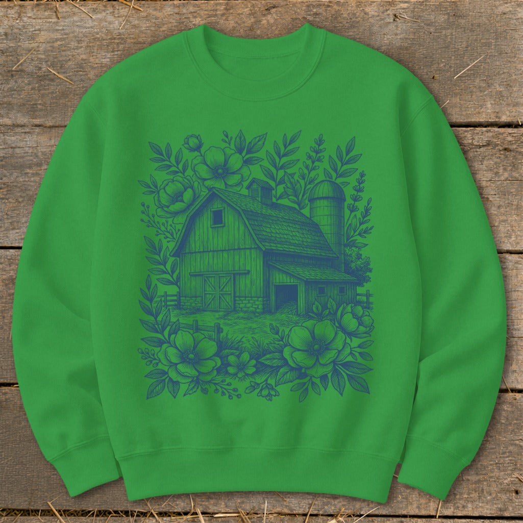 Green sweatshirt with blue barn and floral illustration on front.