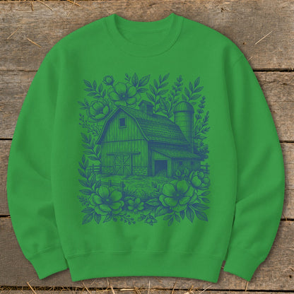 Green sweatshirt with blue barn and floral illustration on front.
