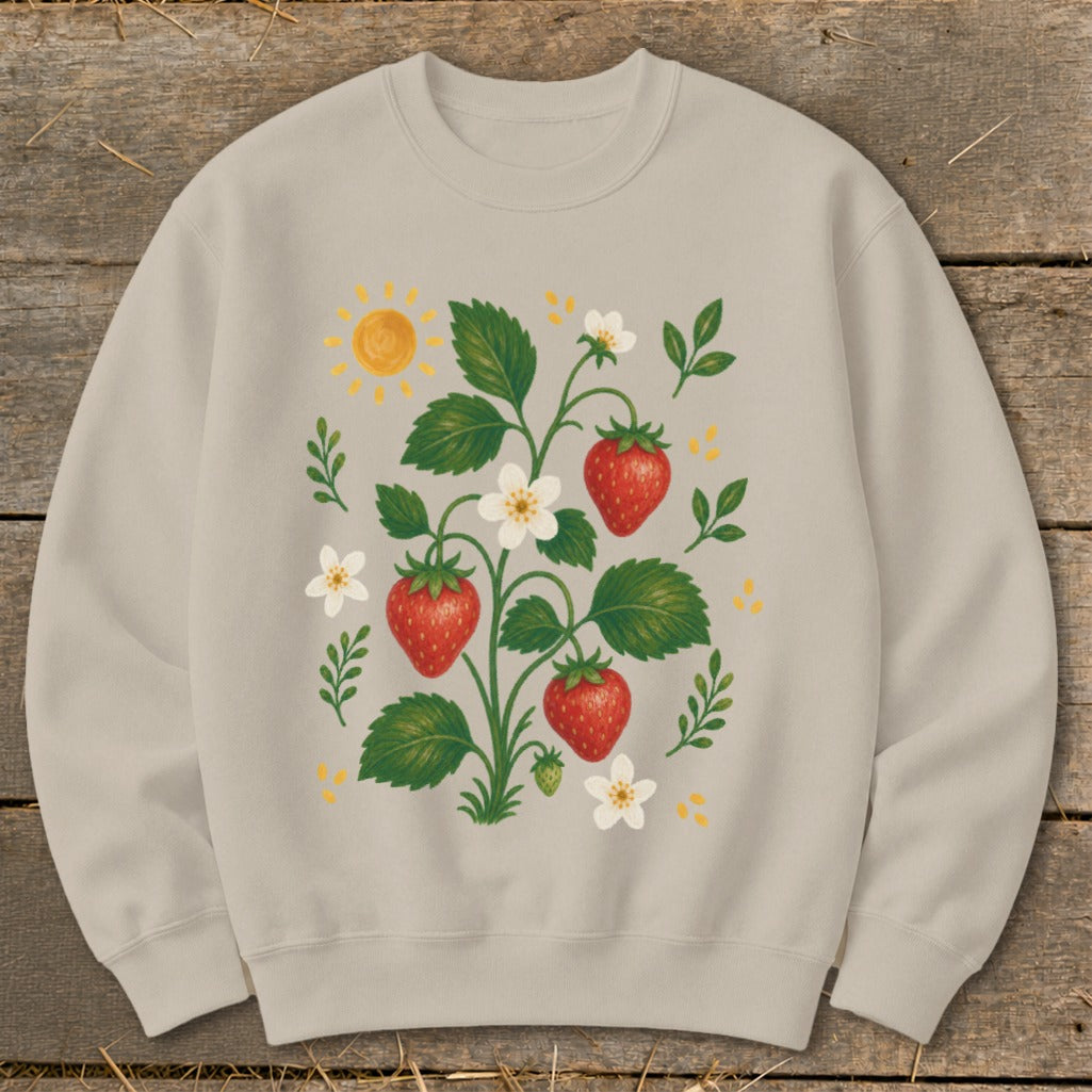 Light tan sweatshirt with a botanical illustration of strawberries, flowers, and a sun.