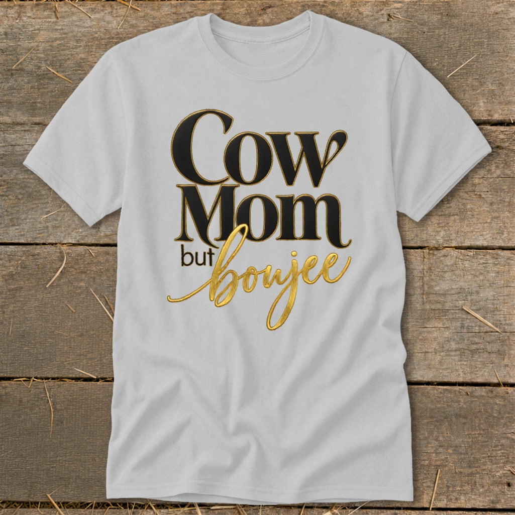 White t-shirt with "Cow Mom but boujee" text in black and gold.