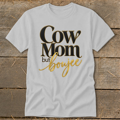 White t-shirt with "Cow Mom but boujee" text in black and gold.