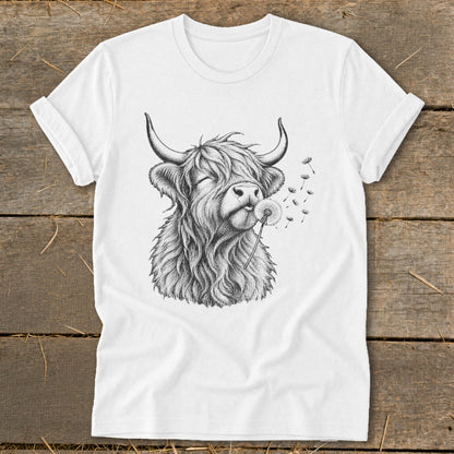 White t-shirt featuring a black and white sketch of a Highland cow blowing dandelions.