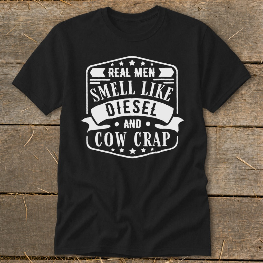 Black t-shirt with white text: Real Men Smell Like Diesel and Cow Crap.