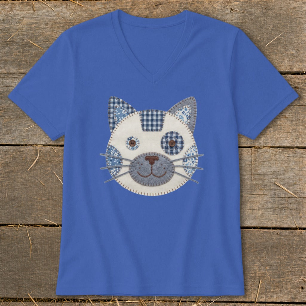 Blue v-neck t-shirt with a blue and white patchwork cat face applique.