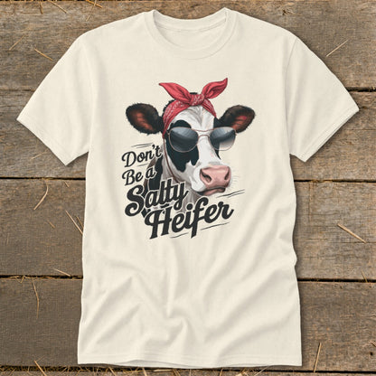 Cream t-shirt with a cow wearing a red bandana and sunglasses, featuring text "Don't Be a Salty Heifer".
