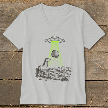 UFO abducting hay bale over a horse in a fenced field with mountains.