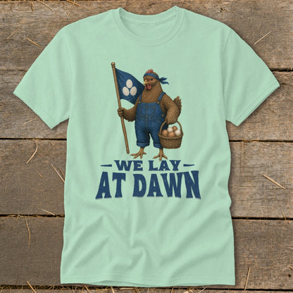 Chicken in overalls holds flag and basket of eggs, text reads "WE LAY AT DAWN".