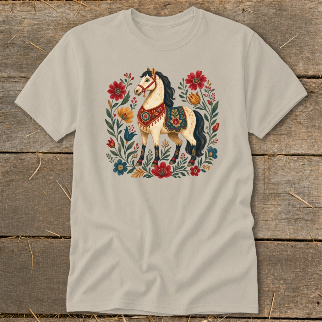 Light tan t-shirt featuring a cream horse adorned with floral saddle and halter.