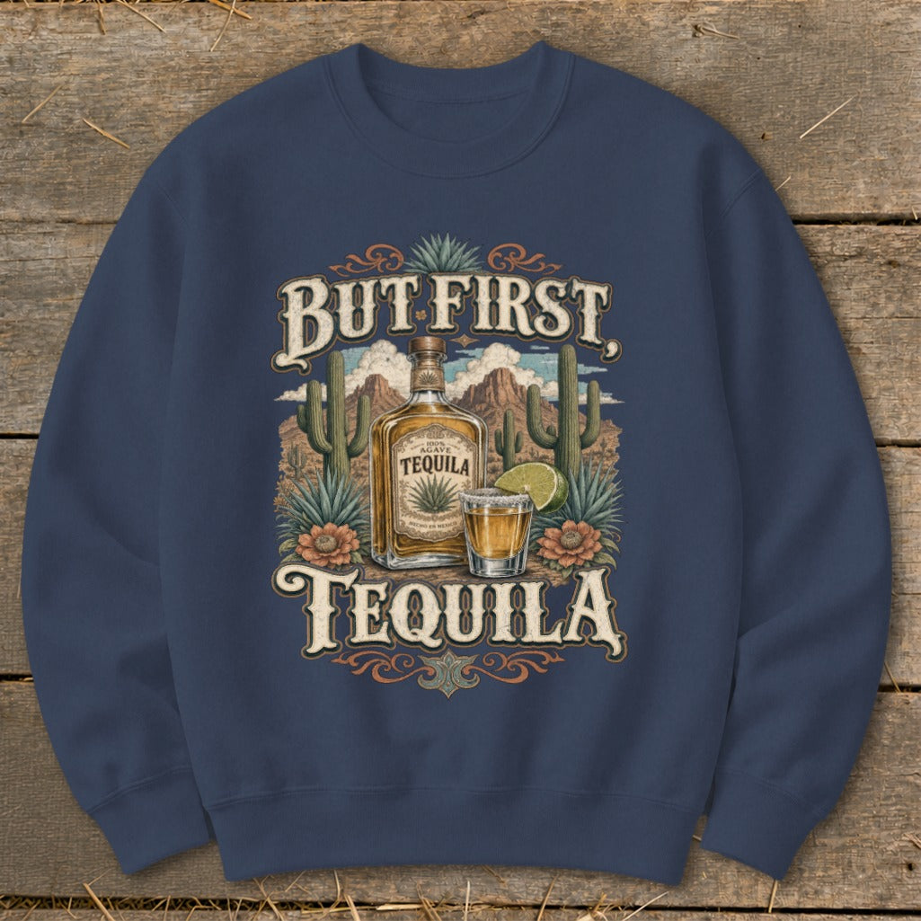Navy sweatshirt with "But First Tequila" graphic featuring a tequila bottle, shot, and desert landscape.