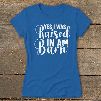 Blue t-shirt with white text "YES I WAS Raised IN A Barn" and a goat silhouette.