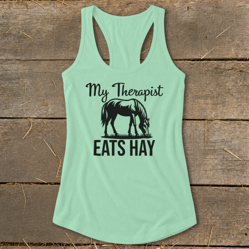 Light green tank top with black text "My Therapist Eats Hay" and a horse graphic.