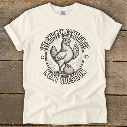 White t-shirt with a chicken and egg graphic, saying "The chicken came first. Next question."