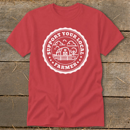 Red t-shirt with white circular logo featuring barn and text "Support Your Local Farmer".