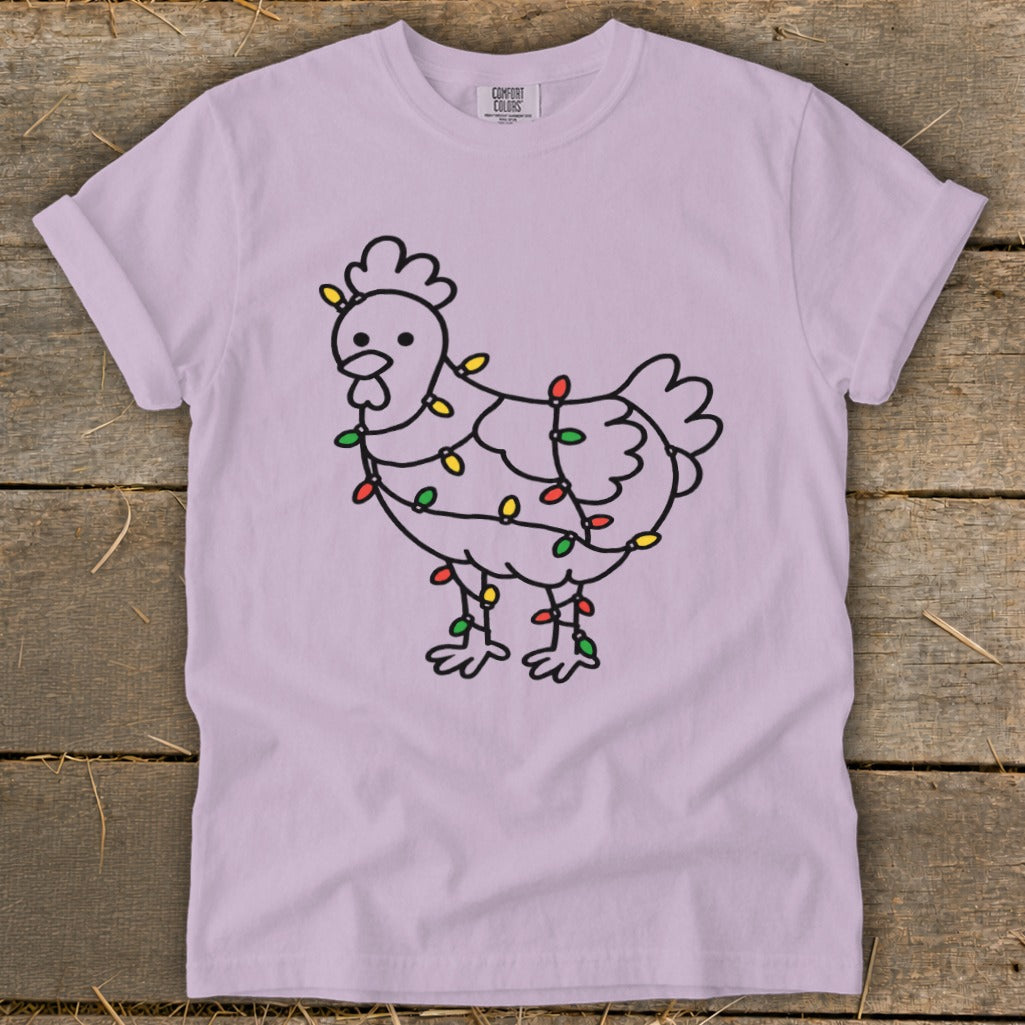 Line drawing of a chicken wrapped in colorful Christmas lights on a lavender t-shirt.