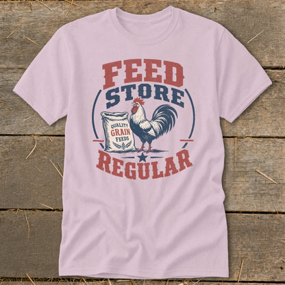 Pink t-shirt with "Feed Store Regular" text, rooster, and grain feed bag graphic.