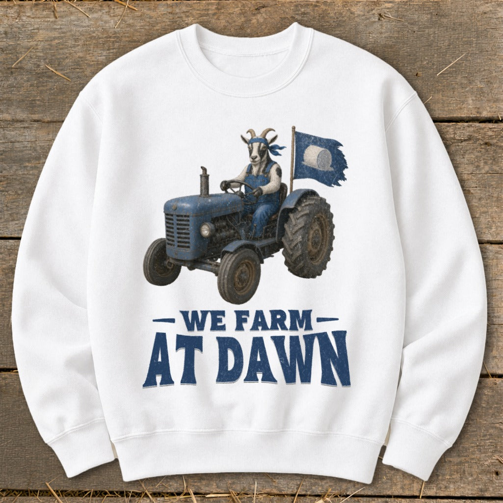 Goat in overalls drives blue tractor, waving a flag. Text reads "We Farm At Dawn."