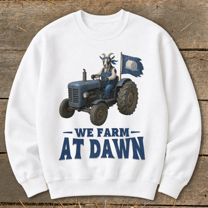 Goat in overalls drives blue tractor, waving a flag. Text reads "We Farm At Dawn."